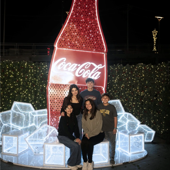 Family exploring the light sculptures and taking holiday pictures